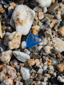 Blue sea glass on the beach